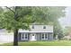 Charming two-story home with gray siding, dark brick accents, white trim, and a well-manicured lawn at 839 Fernwood Ct, Indianapolis, IN 46234