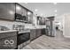 Modern kitchen features stainless steel appliances, gray cabinets, and a subway tile backsplash at 839 Fernwood Ct, Indianapolis, IN 46234