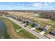 Aerial view of new home construction in a suburban community featuring green spaces and a pond at 1775 Beyers St, Fortville, IN 46040