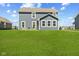 Back exterior of a two-story home with well-maintained lawn, patio and comfortable outdoor seating at 1775 Beyers St, Fortville, IN 46040