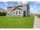 Back exterior with large yard, showcasing the patio and landscaping, perfect for outdoor enjoyment at 1775 Beyers St, Fortville, IN 46040