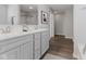 This bathroom features dual sinks with an elegant grey vanity and modern fixtures at 1775 Beyers St, Fortville, IN 46040