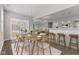 Open concept dining room with seating for ten, an eat-in bar, and sliding doors to the backyard at 1775 Beyers St, Fortville, IN 46040