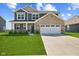 Charming two-story home with manicured lawn and a two-car garage at 1775 Beyers St, Fortville, IN 46040
