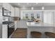 Bright and airy kitchen with white cabinets, stainless steel appliances, and island seating at 1775 Beyers St, Fortville, IN 46040
