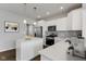 Modern kitchen featuring white cabinets, stainless appliances, and a center island at 1775 Beyers St, Fortville, IN 46040