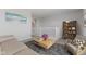 Upstairs living area with a sofa, armchair, and a view of the home's stairway at 1775 Beyers St, Fortville, IN 46040