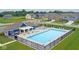Aerial view of community pool with lounge seating, pool house with pergola and well-manicured lawn at 1775 Beyers St, Fortville, IN 46040