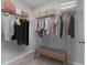This walk-in closet features ample shelving, hanging storage, and a comfy bench at 1775 Beyers St, Fortville, IN 46040