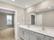 Bright ensuite bathroom featuring double sinks, spacious vanity, and a doorway to the main bedroom at 18322 Depoe Ln, Westfield, IN 46074