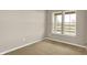 Neutral bedroom with carpet, base trim, and view of the exterior at 18322 Depoe Ln, Westfield, IN 46074