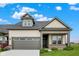Charming single-Gathering home with a gray garage door, manicured lawn, and appealing curb appeal at 18322 Depoe Ln, Westfield, IN 46074