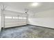 Spacious garage with concrete floor, overhead lighting and garage door at 18322 Depoe Ln, Westfield, IN 46074