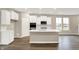 Well-lit kitchen with a central island, stainless appliances, and modern white cabinetry at 18322 Depoe Ln, Westfield, IN 46074