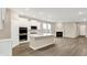 Bright, open kitchen with stainless appliances, a large island, and views into the living area at 18322 Depoe Ln, Westfield, IN 46074