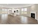Open-concept living space featuring hardwood floors, a fireplace, and a seamless connection to the kitchen at 18322 Depoe Ln, Westfield, IN 46074