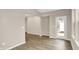 Bright living room with modern neutral paint and wood flooring; doorway with backyard access at 18322 Depoe Ln, Westfield, IN 46074