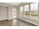 Bright sunroom featuring wood flooring, large windows offering views of the property and access to the backyard at 18322 Depoe Ln, Westfield, IN 46074