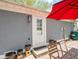 Back door access to the patio, adorned with potted plants, and shaded by a red patio umbrella at 104 W County Road 500 S, Clayton, IN 46118