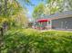 Lush backyard with a patio area featuring a red umbrella, perfect for outdoor dining and relaxation at 104 W County Road 500 S, Clayton, IN 46118