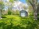 Large backyard features a storage shed, green grass and plenty of shade at 104 W County Road 500 S, Clayton, IN 46118
