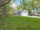 Home's outdoor space with mature trees and a detached garage at 104 W County Road 500 S, Clayton, IN 46118