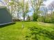 Spacious backyard with a fire pit area and lush green lawn surrounded by trees at 104 W County Road 500 S, Clayton, IN 46118