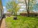 Spacious backyard with a fire pit, patio dining area, and mature trees surrounding the property at 104 W County Road 500 S, Clayton, IN 46118