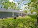 Expansive backyard featuring a patio area, fire pit, and lush green lawn, perfect for outdoor entertaining at 104 W County Road 500 S, Clayton, IN 46118