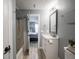 Bathroom with tub and shower combo, with vanity and view to bedroom at 104 W County Road 500 S, Clayton, IN 46118