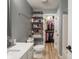 Bathroom featuring a toilet, vanity, and walk-in closet with shelves at 104 W County Road 500 S, Clayton, IN 46118