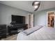 Bedroom with hardwood floors, fan light, TV, and walk-in closet at 104 W County Road 500 S, Clayton, IN 46118