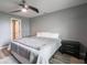 A neutral bedroom featuring a gray bedspread, wood-look floors, and a ceiling fan at 104 W County Road 500 S, Clayton, IN 46118