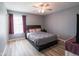 Bedroom featuring a ceiling fan, a black bed frame, and wood-look flooring at 104 W County Road 500 S, Clayton, IN 46118