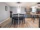 Elegant dining area features a modern lighting fixture, gray cabinets, and new flooring at 104 W County Road 500 S, Clayton, IN 46118