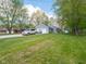 Landscaped home with a wide gravel driveway and detached garage at 104 W County Road 500 S, Clayton, IN 46118