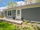 Charming single-story home with gray exterior and manicured lawn, showcasing a welcoming entrance at 104 W County Road 500 S, Clayton, IN 46118