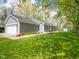 Charming home with attached garage, landscaped front and lush lawn at 104 W County Road 500 S, Clayton, IN 46118
