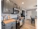 A kitchen featuring gray cabinets, butcher block countertops, and stainless steel appliances at 104 W County Road 500 S, Clayton, IN 46118