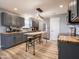 Spacious kitchen featuring gray cabinets, butcher block countertops, and a modern light fixture at 104 W County Road 500 S, Clayton, IN 46118