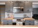 A kitchen featuring gray cabinets, butcher block countertops, and stainless steel appliances at 104 W County Road 500 S, Clayton, IN 46118