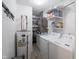Well-lit laundry room with washer, dryer, water heater, and ample storage space at 104 W County Road 500 S, Clayton, IN 46118