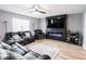 Cozy living room showcases an electric fireplace, mounted television, and comfortable leather furniture at 104 W County Road 500 S, Clayton, IN 46118