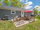 Cozy outdoor patio with dining set, shaded by a vibrant red umbrella, and perfect for outdoor entertaining at 104 W County Road 500 S, Clayton, IN 46118