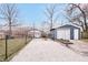 Fenced backyard with gravel area and detached garage, offering parking and additional storage at 1829 New St, Indianapolis, IN 46203