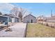 View of backyard with detached garage and partial view of house showing driveway and greenery at 1829 New St, Indianapolis, IN 46203