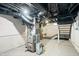 Exposed basement with painted concrete walls and ceiling with exposed ductwork, and utility components at 1829 New St, Indianapolis, IN 46203