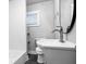 Compact bathroom with subway tiled shower and black tiled floor, contemporary white sink and vanity at 1829 New St, Indianapolis, IN 46203