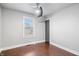 Bright bedroom with neutral walls, ceiling fan, window with blinds, and hardwood-style flooring at 1829 New St, Indianapolis, IN 46203