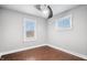 Neutral bedroom with a ceiling fan, two windows offering natural light, and wood-look floors at 1829 New St, Indianapolis, IN 46203